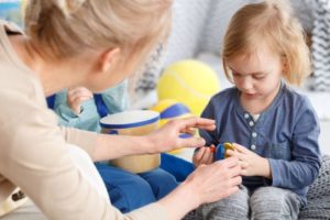 Woman helping young child