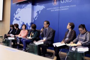 Seven panelists focused on one panelist speaking
